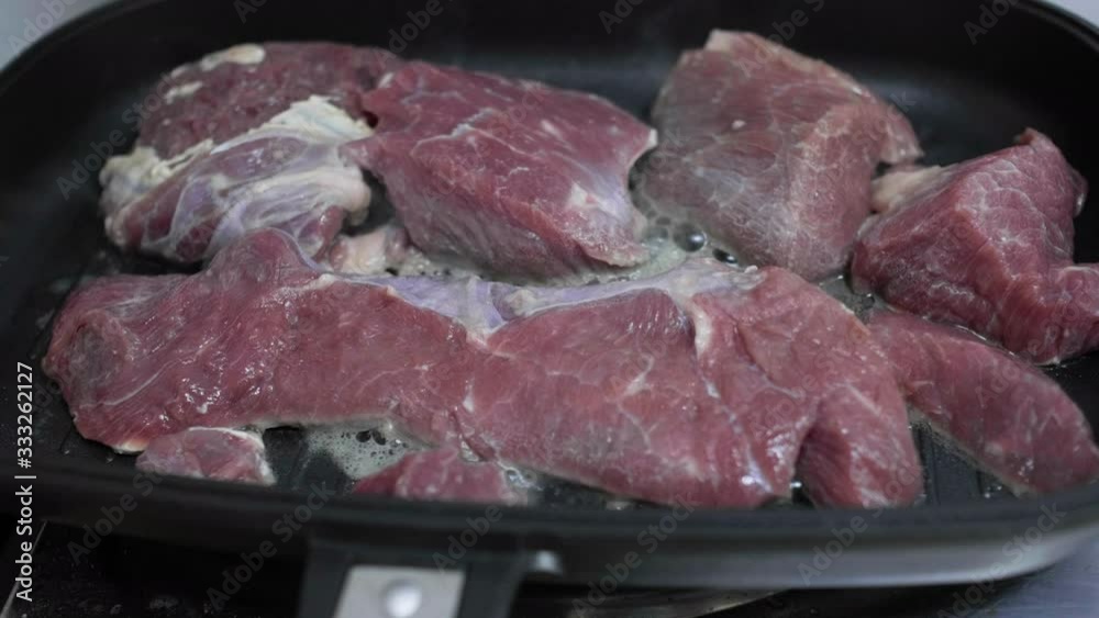 Roasting pieces of red beef meat in the kitchen Roasting pieces of red beef meat in the kitchen