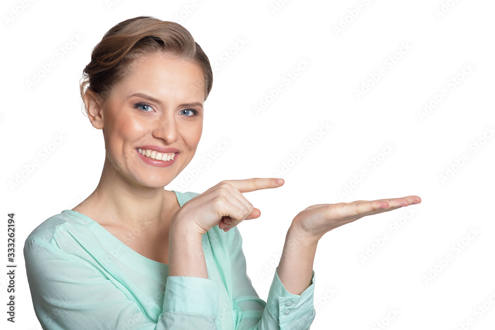 Portrait of beautiful young woman showing something