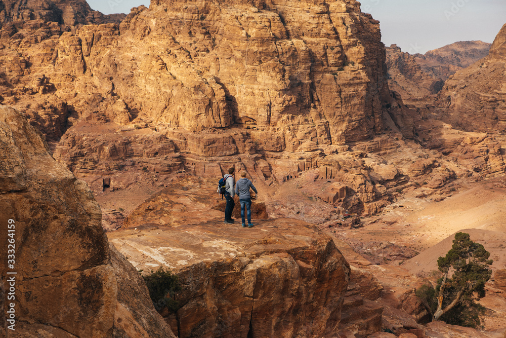 Two male tourst observing the mountain city of Petra, Jordan