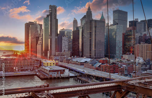 New York skyline from Brooklyn Bridge at sunset