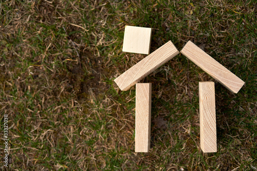 Wooden blocks in a shape of a house can be used as copy space or use for concepts