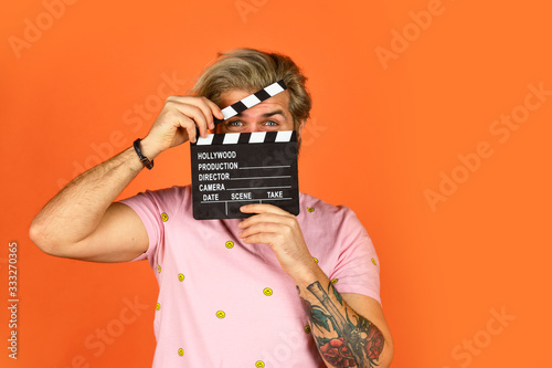 Actor casting. Shooting scene. Favorite series. Cinema production. Creative producer. Bearded man hold movie clapper. Film maker. Clapperboard copy space. Comedy or drama. Watch movie. Film director photo