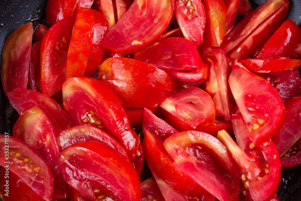 tomato frying on pan, cooking vegetable sauce, kitchen.