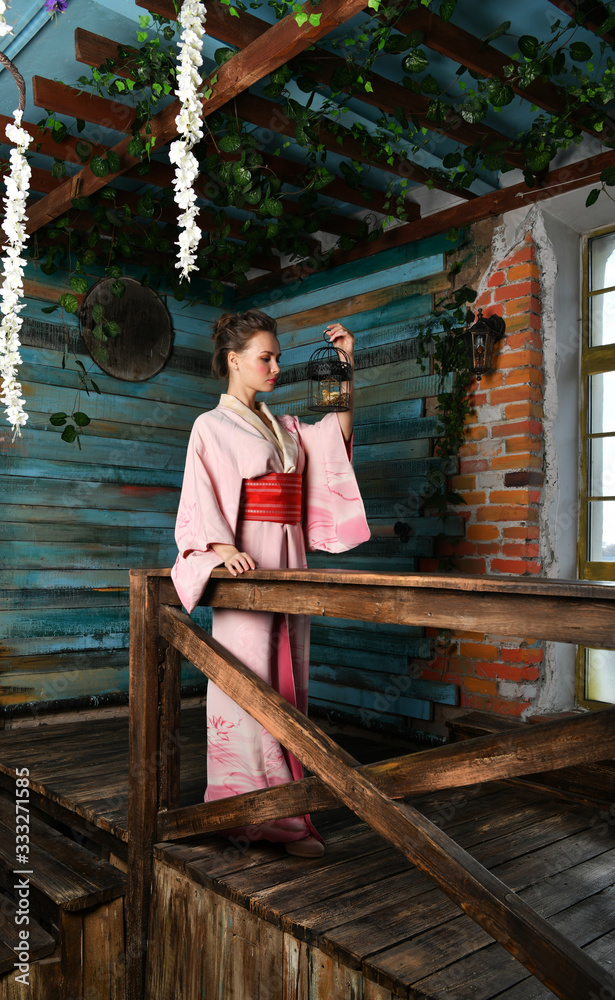 beautiful girl in a pink kimono with a cage with a bird beautiful girl in a pink kimono with a cage with a bird
