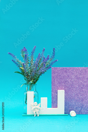 Letter object with lavender and angel object with a shiny purple and blue background photo