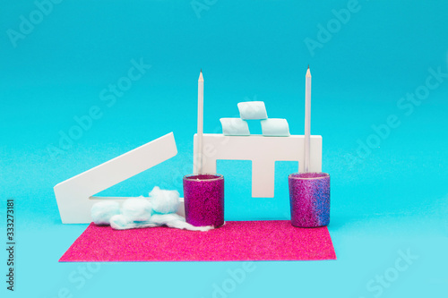 Letter objects with marshmallows and candle holders on a blue and purple background photo