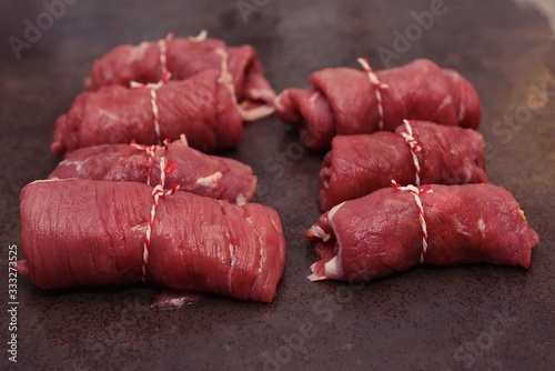 Raw beef roulades of Angus - Rohe Rinderrouladen vom Angusrind mit Wurstgarn photo