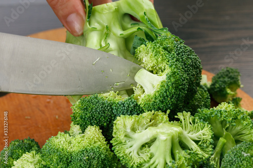 Chef cutting fresh green br...
