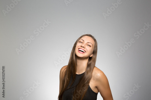 Studio portrait of a young woman laughing