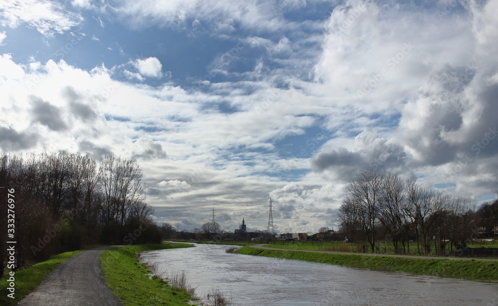 In winter, after a lot of rain, the water level of the Demer is very high. Meadows are flooded. Image of the river Demer in Langdorp, near Aarschot, Flanders, Belgium.