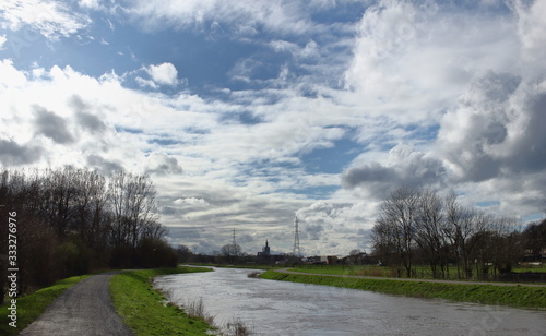 In winter, after a lot of rain, the water level of the Demer is very high. Meadows are flooded. Image of the river Demer in Langdorp, near Aarschot, Flanders, Belgium. photo