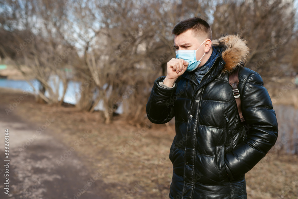 Prevention of coronavirus outbreak in 2020. Outdoor portrait of european man wearing a disposable facial mask. Prevent pollution and disease concept. Prevention of coronavirus outbreak in 2020. Outdoor portrait of european man wearing a disposable facial mask. Prevent pollution and disease concept.