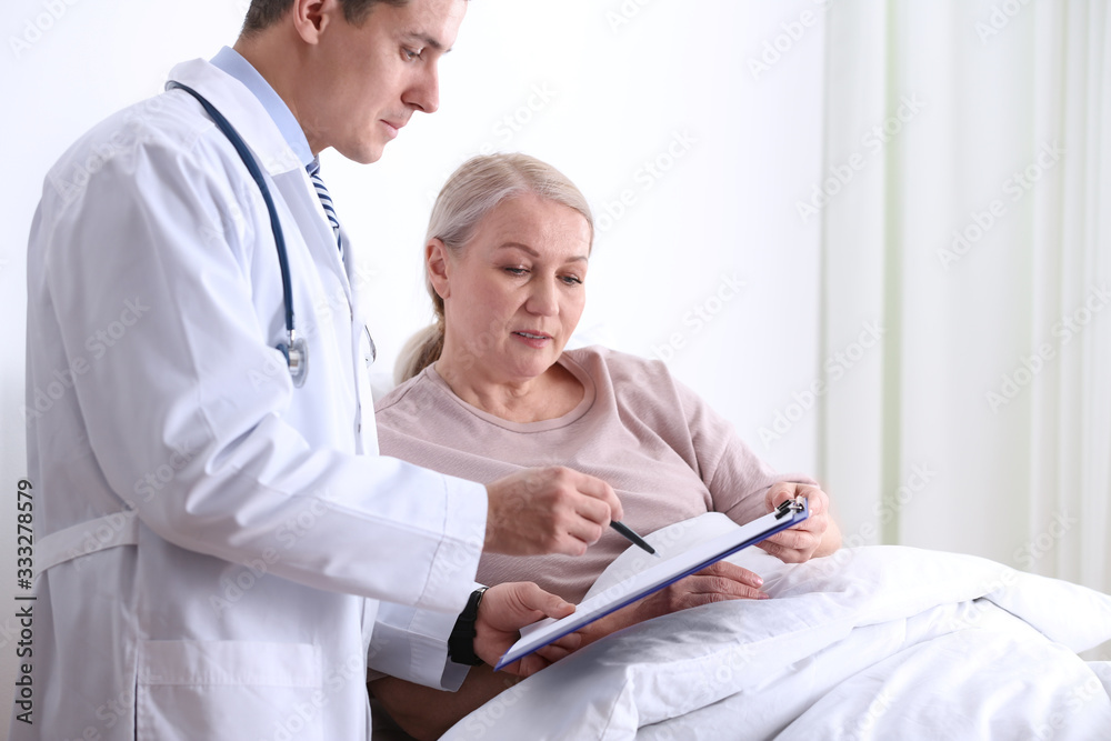 Doctor visiting his patient in hospital ward Doctor visiting his patient in hospital ward