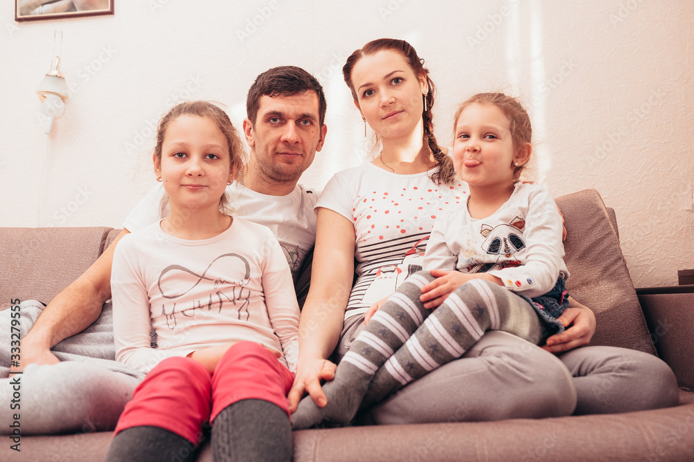 Happy family at home on the couch