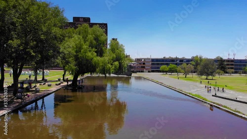 Dog playing in a mirror of water in the university city of the UNAM of mexico city photo