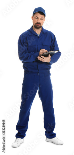 Full length portrait of professional auto mechanic with clipboard on white background
