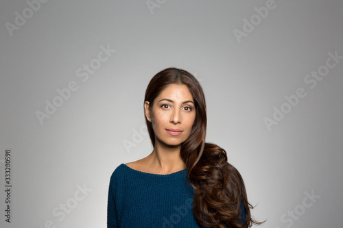 Portrait of a woman against gray background