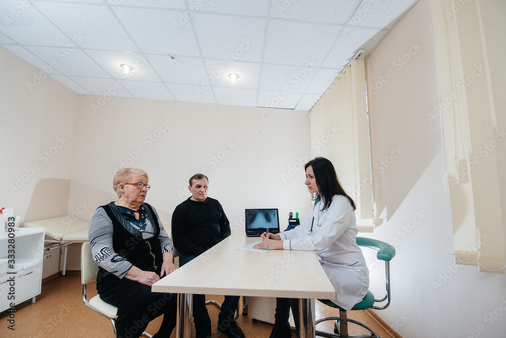 A couple of elderly people at a personal doctor's appointment at a medical center. Medicine and healthcare A couple of elderly people at a personal doctor's appointment at a medical center. Medicine and healthcare