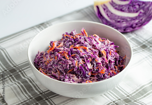 Red cabbage and carrot salad, healthy coleslaw in white bowl
