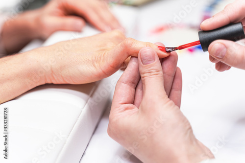 Focused photo on female hand that holding nail polish