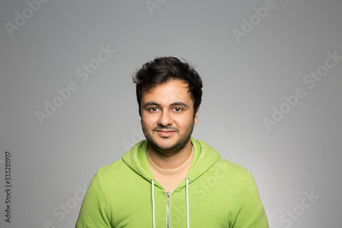 studio portrait of a young man contemplating