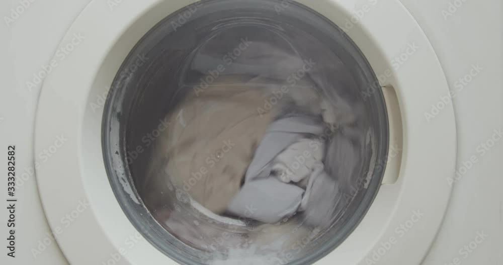 Closeup of a front load washing machine cleaning clothes Closeup of a front load washing machine cleaning clothes