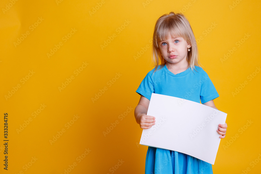 a little girl holding an empty piece of paper is crying a little girl holding an empty piece of paper is crying