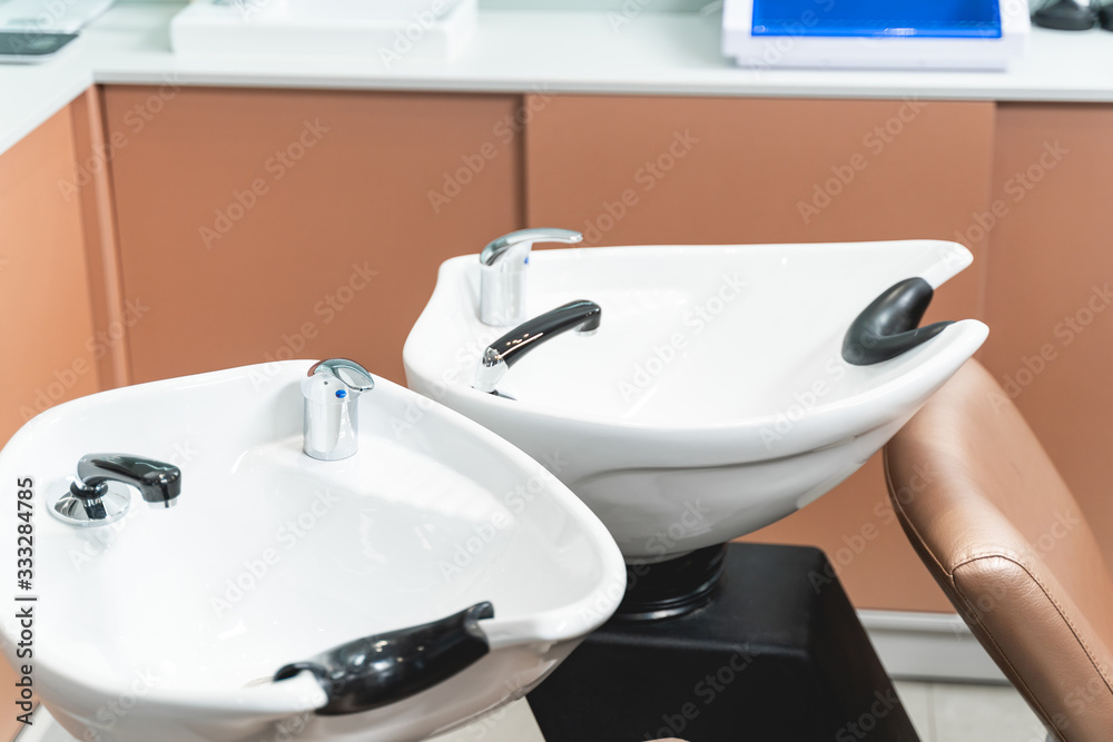 Fototapeta premium Focused photo on professional sinks that being in salon