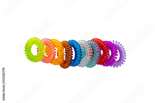 Hair care tools isolated. Close-up of multicolored elastic spiral scrunchies or hair bands for women hairstyling isolated on a white background. Tools from hairdresser and beauty salon.