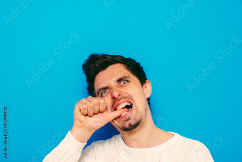 man bites his nails