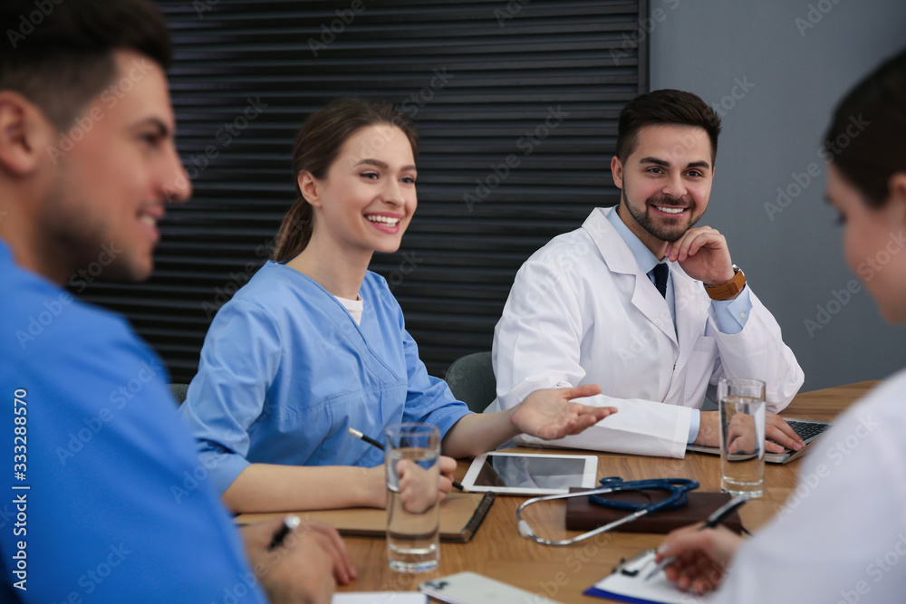 Team of professional doctors having meeting in office Team of professional doctors having meeting in office