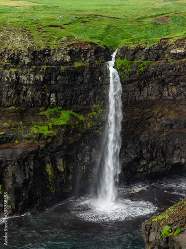 Faroe Islands. Múlafossur Waterfall. Vertical. Long exposure.