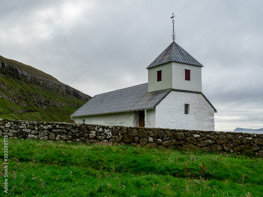 Faroe Islands. Kirkjubøur. Old and white church.