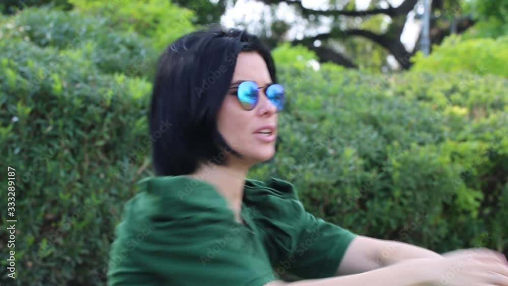 Beautiful girl enjoying nature outdoors in a park. The girl laughs and rejoices, a positive emotion. Beautiful girl enjoying nature outdoors in a park. The girl laughs and rejoices, a positive emotion.