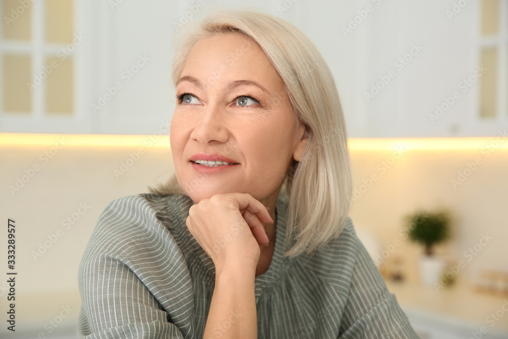 Portrait of beautiful mature woman in kitchen Portrait of beautiful mature woman in kitchen