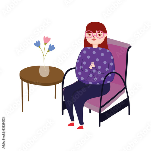 young woman wearing glasses sitting in chair © Stockgiu