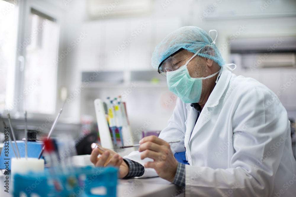 Biologist working with sample in petri dish in laboratory Biologist working with sample in petri dish in laboratory