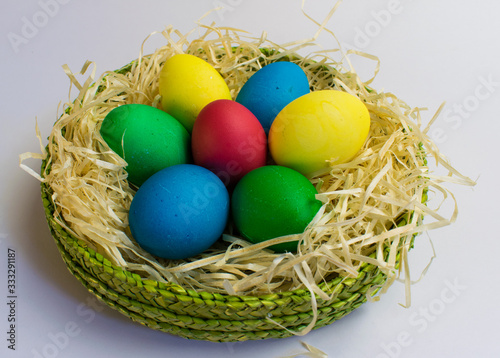 Colored eggs in a green basket