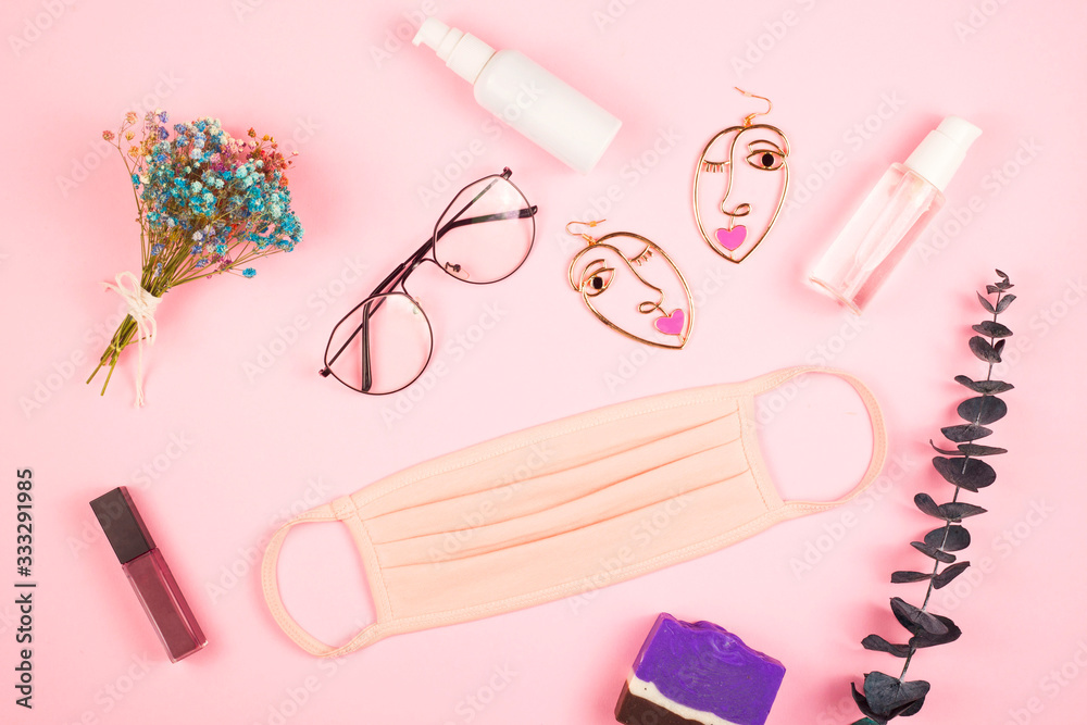 Pink medical mask for women to protect against the virus Kovid 19. The layout on a pink background. Spring 2020 style. Pink medical mask for women to protect against the virus Kovid 19. The layout on a pink background. Spring 2020 style.