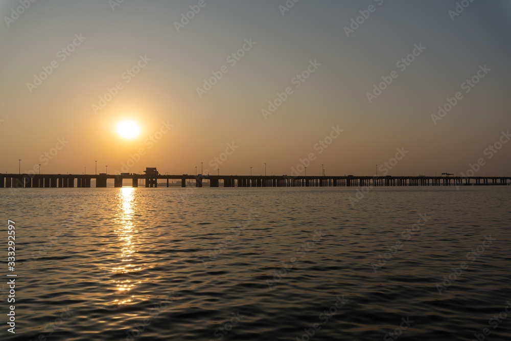 Bridge in the sea at sunset moment