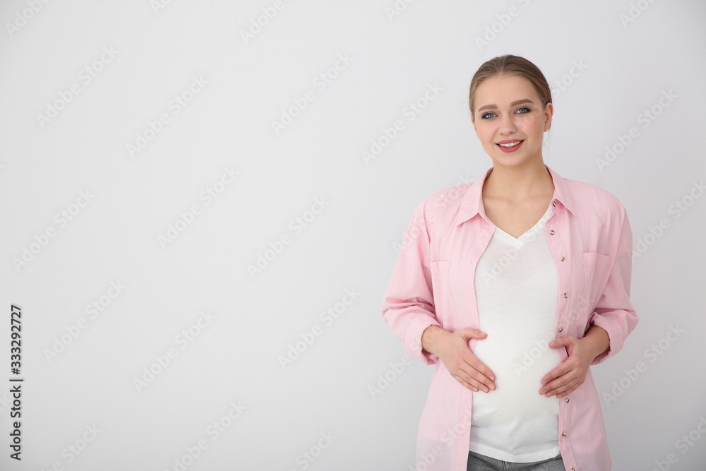 Young pregnant woman on white background. Space for text Young pregnant woman on white background. Space for text