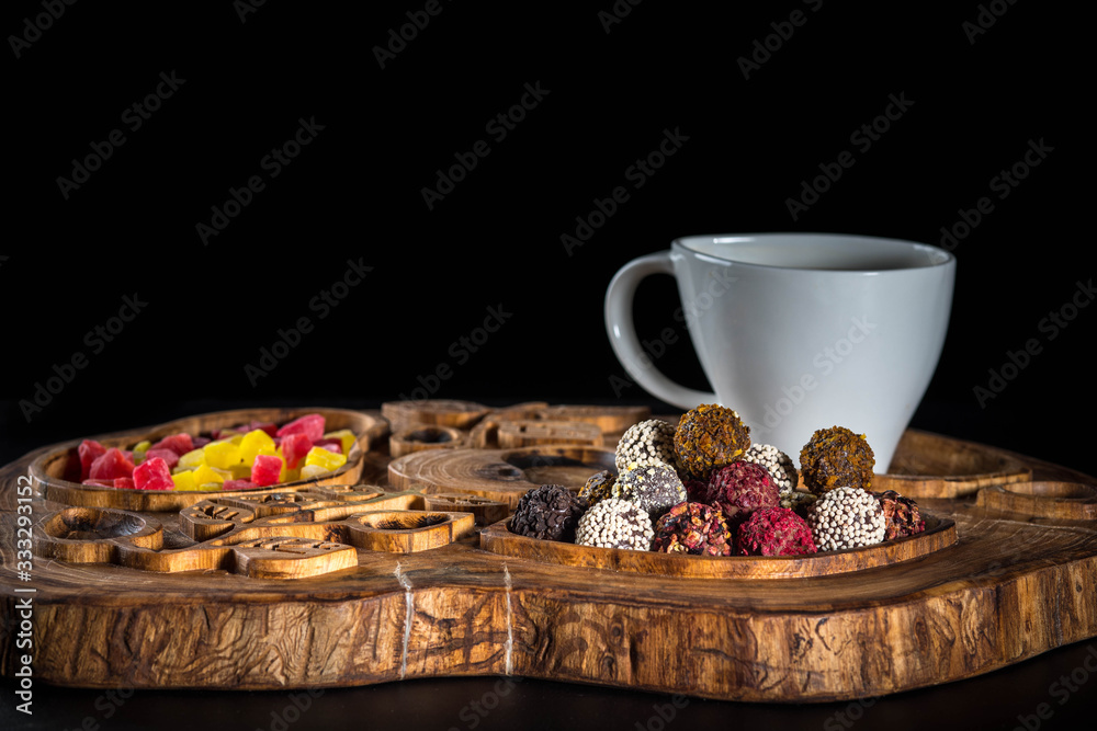 cup of coffee, chocolate candies and cookies on table cup of coffee, chocolate candies and cookies on table