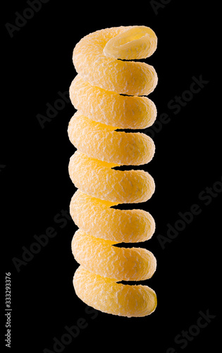 Macro photo of yellow fusilli pasta isolated on black with clipping path photo