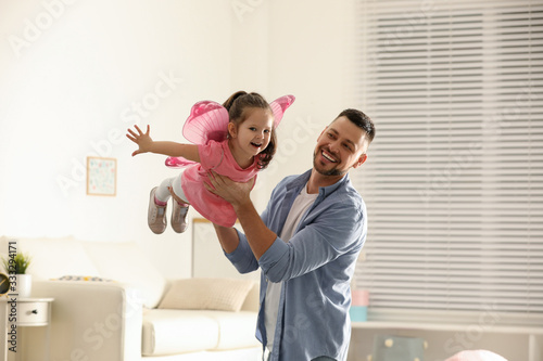Father playing with his child at home