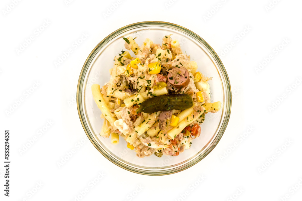 Pasta salad dish with corn, tuna and a pickle Pasta salad dish with corn, tuna and a pickle