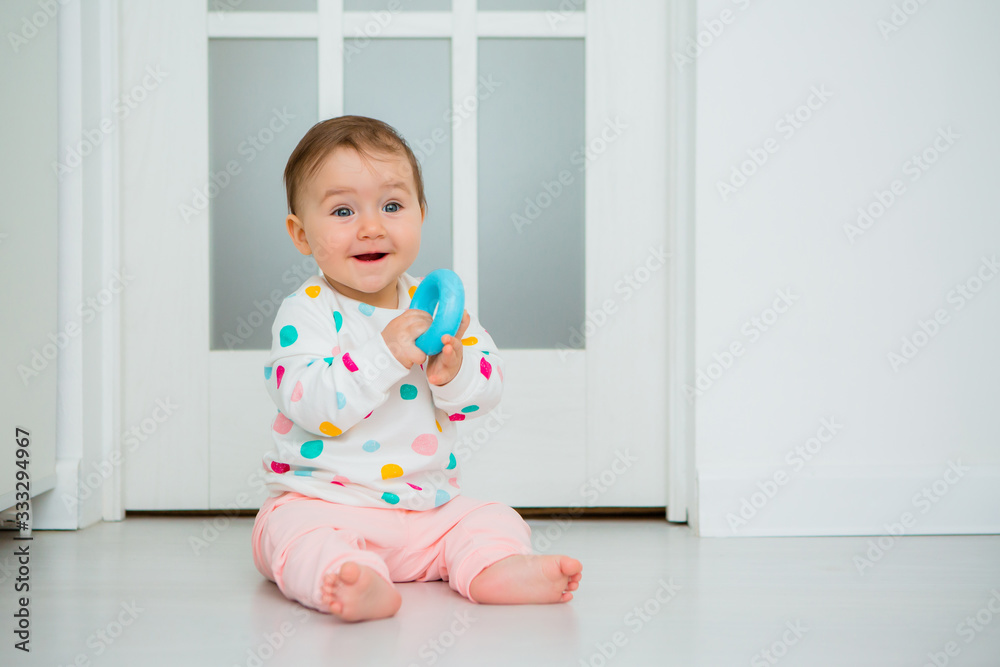 Toddler girl plays educational games at home. Baby sits on the floor of the house Toddler girl plays educational games at home. Baby sits on the floor of the house
