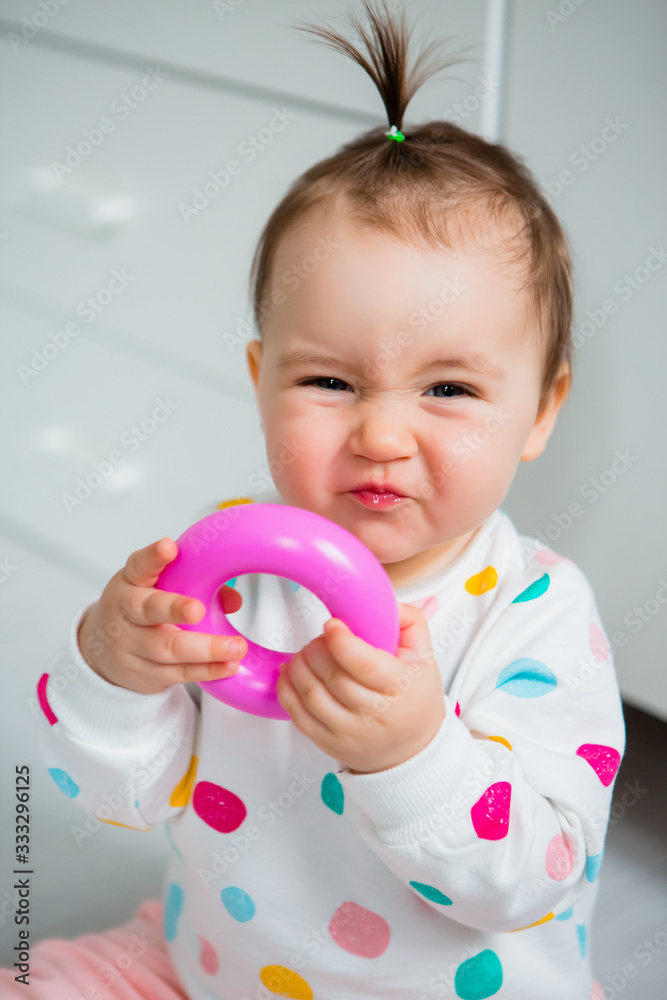 portrait of a child. Toddler girl smiles and looks into the camera portrait of a child. Toddler girl smiles and looks into the camera