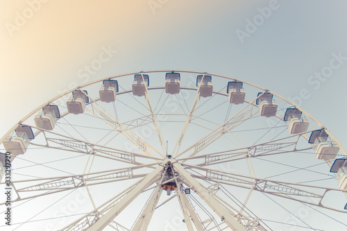 Light ferris wheel without people and piece sunlight. Vintage style. Close-up.
