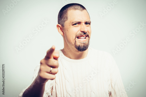 Young man showing his index finger towards the camera