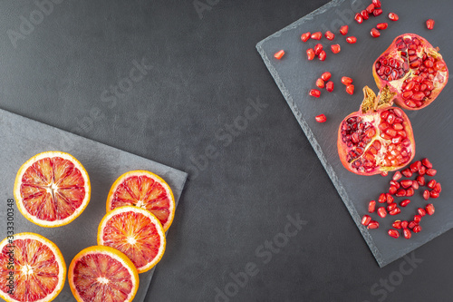 Sicilian red orange and pomegranate on background, copy space